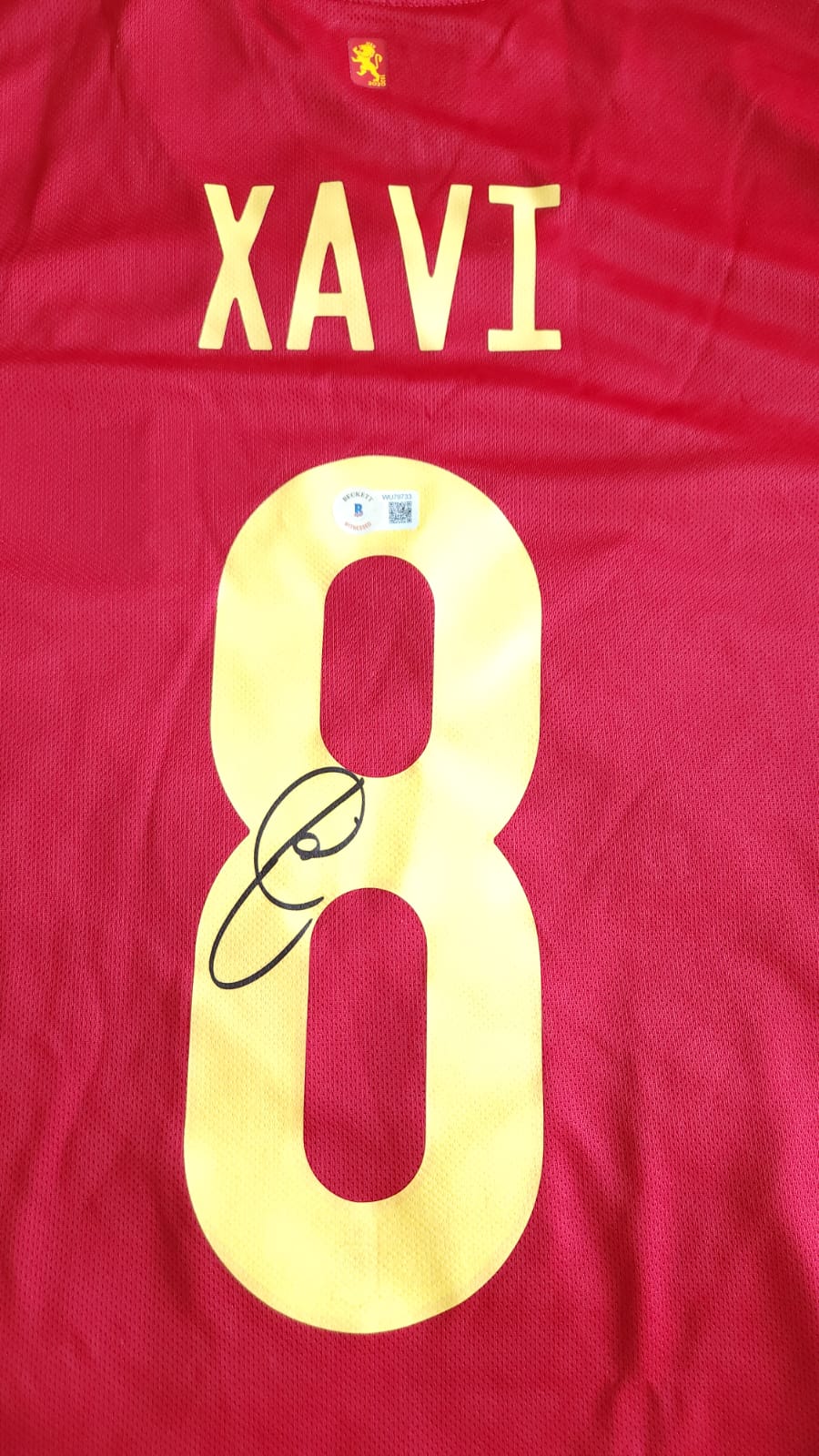 Playera autografiada por Xavi Hernández firma autentificada por la compañía Beckett con el número WU79733.