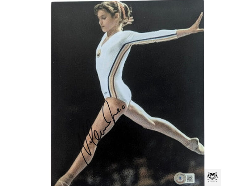 Nadia Comaneci en la barra fotografía autografiada certificada por Beckett BG02372